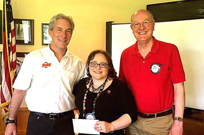 Daniel Lacy (left) accepts Tualatin Rotary Club Legacy Grant from Jessica Cousineau and Mike Bunce.