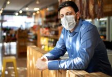 New law extends COVID tax credit for employers Man Wearing Mask