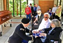 Former City Council Member Ed Truax’s family receive closure for his uncle who went Missing in Action in 1950 in the Battle of Chosin Reservoir with remains identified, then military funeral at Willamette National Cemetery Presentation of flag to Ed’s mother, with Ed and his brother John beside her.