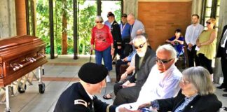 Former City Council Member Ed Truax’s family receive closure for his uncle who went Missing in Action in 1950 in the Battle of Chosin Reservoir with remains identified, then military funeral at Willamette National Cemetery Presentation of flag to Ed’s mother, with Ed and his brother John beside her.