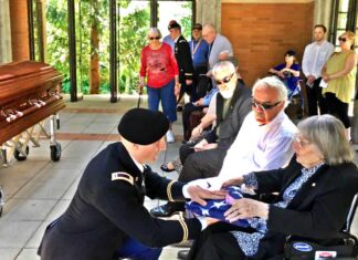 Former City Council Member Ed Truax’s family receive closure for his uncle who went Missing in Action in 1950 in the Battle of Chosin Reservoir with remains identified, then military funeral at Willamette National Cemetery Presentation of flag to Ed’s mother, with Ed and his brother John beside her.
