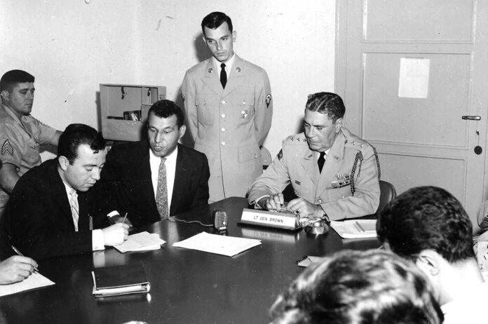 David, standing, interpreting his first NATO press conference in Turkey. Issue was NATO involvement with US agreement to dismantle missile sites in Turkey and Italy to help defuse Cuban Missile Crisis. Although nuclear-tipped missiles were a national major concern, newspapers the next day seemed more interested in the Turkish Speaking American.