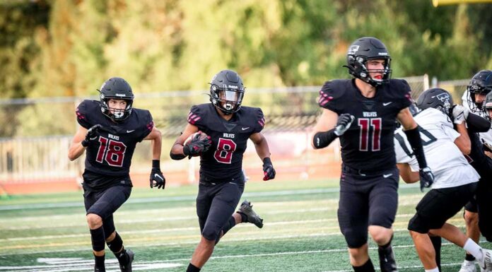 Tualatin football scrapes by in head-to-head with 5A’s finest Senior Malik Ross (8), with aid from AJ Noland (18) and Peter Burke (11), secures an 85-yard touchdown.