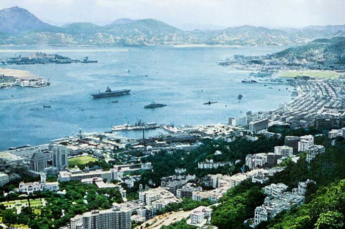 1957 picture of an aircraft carrier in Hong Kong.