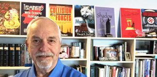 Dave Dehart retires from Army with 20 years military service at age 37, Now using intelligence service experience to write novels for third career Dave in his library which features the books he has authored.