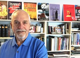 Dave Dehart retires from Army with 20 years military service at age 37, Now using intelligence service experience to write novels for third career Dave in his library which features the books he has authored.