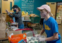 Tualatin Food Pantry fills a vital need in the local community Volunteer Barbara Feist (rear) and her daughter, Davina Barber, unload freshly donated boxes of canned and packaged goods.