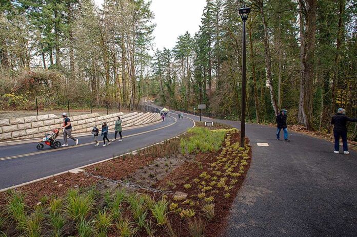 Tualatin residents walk along a newly completed roadway.