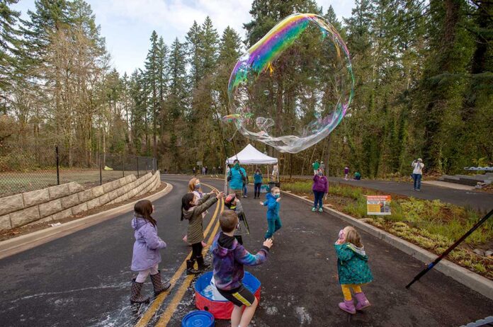 Children play in the street during a Nov. 20 celebration of the Garden Corner Curves project.