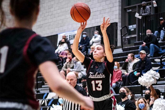 Anna Sherman (13) secures an opening and puts one up from three against Mountainside. Sherman scored the only three-pointer of the night from the Wolves in her five points scored.