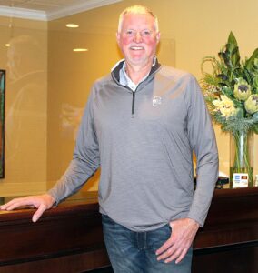 Sitton stands at the reception desk inside Tualatin’s Century Hotel ready to welcome guests.