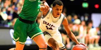 Tualatin gets its title! Tualatin’s Josiah Lake (14) squeezes by Summit’s Truman Teuber (3) for an early 4th quarter bucket.
