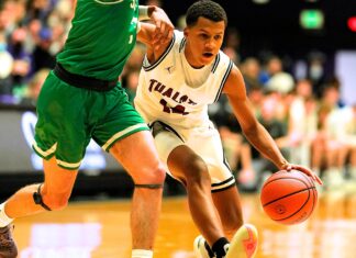 Tualatin gets its title! Tualatin’s Josiah Lake (14) squeezes by Summit’s Truman Teuber (3) for an early 4th quarter bucket.
