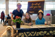 Dressed to Dream formalwear giveaway puts the glitz in prom for area teens Event organizer Cyndy Hillier (standing) joins volunteer greeters Keira Morthland (left) and Ellie Emery in welcoming guests to Dressed to Dream