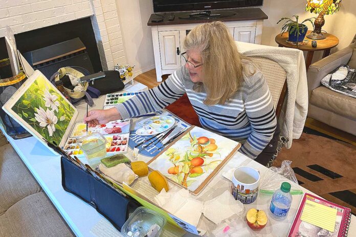Wild Over Watercolor member Karen Berg working on a painting at a WOW! meeting.