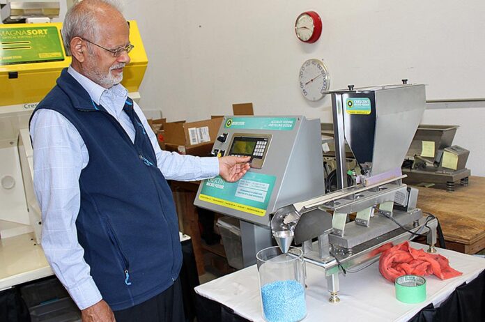 At his Tualatin business, Gulzar Ahmed demonstrates how products are moved along a vibrating conveyer belt.