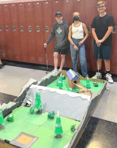 Freshman Stephen Pettitt, Mariah Aguilar, Braeden Salzman, and Nolan Schekel (not pictured) designed a mountain-themed, multi-route miniature golf hole, complete with a water hazard, for Design Core’s family night.