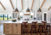 Add Personality to your Home this Year This modern farmhouse kitchen mixes painted cabinets with a rift-sawn white oak island.
