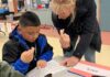 Rotary Helps Tualatin Students Define Success & Service Rotarian Dr. Julie Spaniel practices sign language with a Tualatin Elementary student.