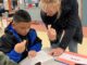 Rotary Helps Tualatin Students Define Success & Service Rotarian Dr. Julie Spaniel practices sign language with a Tualatin Elementary student.