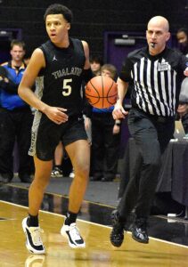 Josiah Lake (5) drives the lane for a layup and the lead just moments after the opening tip in Saturday’s 60-47 win over West Linn for the 6A championship.