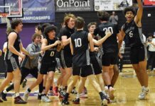 Back-to-Back State Champs! The Timberwolves swarm midcourt to celebrate after the final horn sounds.