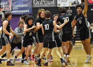 Back-to-Back State Champs! The Timberwolves swarm midcourt to celebrate after the final horn sounds.