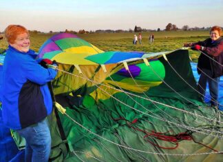 Taking Flight: Tigard Festival of Balloons seeks volunteers to keep event soaring Longtime balloon crew members Marilyn Barnhart (L) and Edie Stoaks hold the opening of a hot air balloon to assist in its inflation. Both women have volunteered on crew since the 1990s.