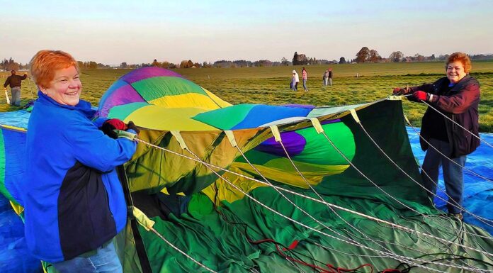 Taking Flight: Tigard Festival of Balloons seeks volunteers to keep event soaring Longtime balloon crew members Marilyn Barnhart (L) and Edie Stoaks hold the opening of a hot air balloon to assist in its inflation. Both women have volunteered on crew since the 1990s.