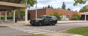 A Tualatin Police cruiser sits in front of Hazelbrook Middle School after the school was evacuated following a bomb threat.