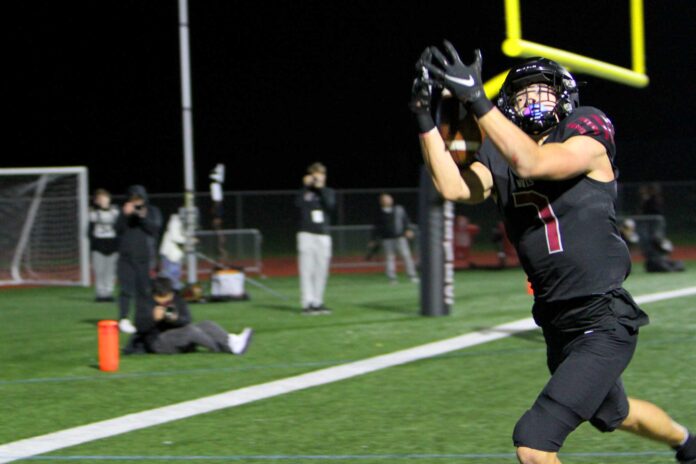 Tualatin receiver AJ Noland hauls in the first of two touchdown catches in a 47-14 win in the second round of the playoffs.