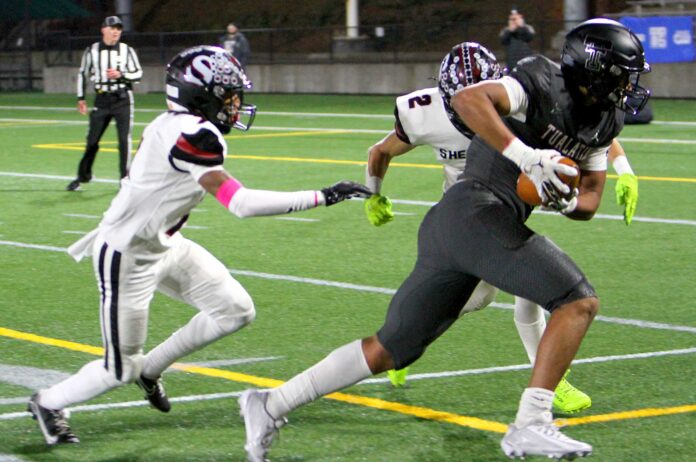 Tualatin star Jayden Fortier finishes off a long reception in a 42-23 win, in which the tight end had four touchdown catches.