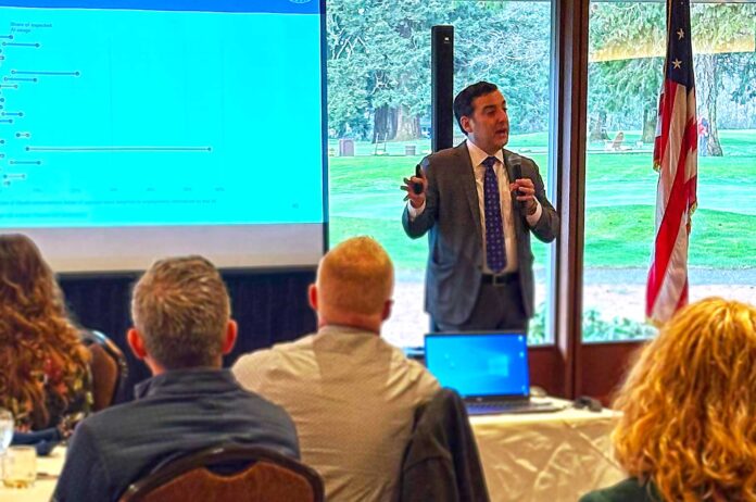 Oregon-State-Economist-Carl-Riccadonna-IMG_4822 State Economist Carl Riccadonna presenting at the Tualatin Chamber’s 2026 State and National Economic Outlook breakfast.