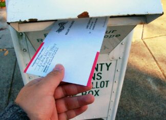Supreme Court skeptical of allowing states to count mail ballots that arrive after Election Day An Oregonian slides their completed ballot into a secure return box, a fixture of the state's all-mail voting system for over 25 years.