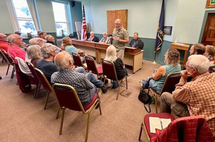 Roger Averbeck addresses his neighbors at a meeting of the Wallowa County Commission on Aug. 23, 2023. A new law meant to clarify what Oregon's public officials can discuss in serial communications to one another, such as calls and texts, is concerning to journalists and ethics watchdogs who say it erodes public meetings laws and allows important decisions to be made in private. (Photo by Matt Vasilogambros/Stateline)