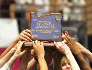 The Tualatin boys basketball team lifts up the state title, the first for the program since 2023.