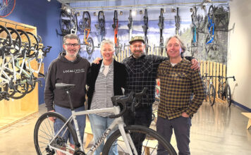 New Tualatin Bike/Coffee Shop combines riding and roasting Business partners Joe Holcomb and Stacey Daley stand alongside Service Manager Kurt Eisley and business partner Ken McClenahan.