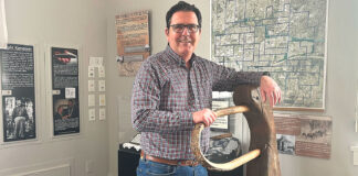 Tualatin Historical Society President Reflects After Retirement Ross Baker stands with Oregon pioneer George Saum’s yoke at the Tualatin Heritage Center on March 17, 2026.