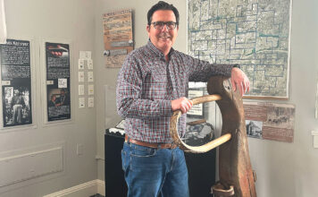Tualatin Historical Society President Reflects After Retirement Ross Baker stands with Oregon pioneer George Saum’s yoke at the Tualatin Heritage Center on March 17, 2026.