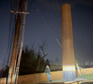 A pole on Stafford road at night.