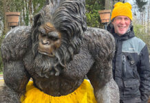Extensive Circus Training A man with a Bigfoot statue.