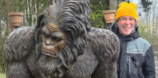 Extensive Circus Training A man with a Bigfoot statue.