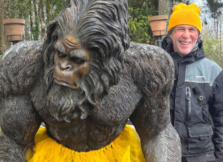 Extensive Circus Training A man with a Bigfoot statue.
