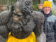 Extensive Circus Training A man with a Bigfoot statue.