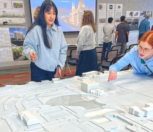 UO architecture students reimagine downtown Tualatin Laura Lopez (left) and Alex Schulte, third-year students in a University of Oregon architectural program, finetune placement of building replicas on a relief map of Tualatin’s downtown. They were participating in a March 10 symposium to exhibit their thoughts on the district’s rejuvenation.