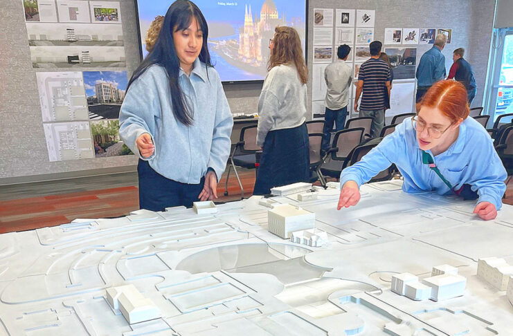 UO architecture students reimagine downtown Tualatin Laura Lopez (left) and Alex Schulte, third-year students in a University of Oregon architectural program, finetune placement of building replicas on a relief map of Tualatin’s downtown. They were participating in a March 10 symposium to exhibit their thoughts on the district’s rejuvenation.