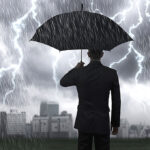 Hunkering Down A man with an umbrella in a storm