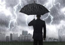 Hunkering Down A man with an umbrella in a storm