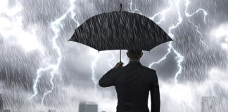 Hunkering Down A man with an umbrella in a storm