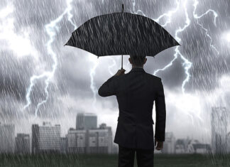 Hunkering Down A man with an umbrella in a storm